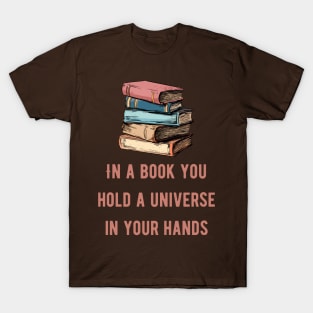 In a book you hold a universe in your hands pink text T-Shirt